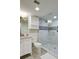 This bathroom features a glass shower, white vanity with marble countertop, tiled walls with blue accents, and modern fixtures at 2909 Atrium Villa, 9, Seabrook Island, SC 29455
