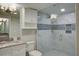 The bathroom features a spacious glass shower, white vanity with marble countertop, and tiled walls with blue accents at 2909 Atrium Villa, 9, Seabrook Island, SC 29455
