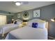 Comfortable bedroom setting with two twin beds featuring blue accents, and soft, white bedding and plenty of natural light at 2909 Atrium Villa, 9, Seabrook Island, SC 29455