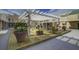Community courtyard with mature landscaping, a fountain, bench seating, and covered pergola in an inviting outdoor space at 2909 Atrium Villa, 9, Seabrook Island, SC 29455