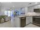 Bright, open kitchen with stainless steel appliances and a view into the living area at 2909 Atrium Villa, 9, Seabrook Island, SC 29455