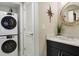 A combined laundry and vanity area includes a stacked washer and dryer with decor accents and plenty of storage space at 2909 Atrium Villa, 9, Seabrook Island, SC 29455
