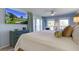 This main bedroom features a TV, large windows and sliding glass doors leading to an outdoor space, and comfortable furniture at 2909 Atrium Villa, 9, Seabrook Island, SC 29455