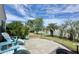 Backyard patio featuring outdoor seating and a view of the pond and palm trees at 310 Waterlily Way, Summerville, SC 29486
