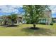 Spacious backyard with well-maintained lawn and mature trees near a beautiful house at 310 Waterlily Way, Summerville, SC 29486
