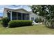 Well-kept backyard with green grass, lush foliage, and a view of the home's exterior at 310 Waterlily Way, Summerville, SC 29486