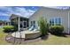 Landscaped backyard with patio, outdoor seating, and a view of the home at 310 Waterlily Way, Summerville, SC 29486