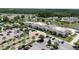 Aerial view of the Del Webb clubhouse, showcasing the large parking lot, walking trails, and community amenities at 310 Waterlily Way, Summerville, SC 29486