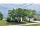 Beautiful home with lush landscaping, mature trees, and well-maintained lawn at 310 Waterlily Way, Summerville, SC 29486