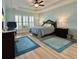 Serene bedroom featuring a tray ceiling, plantation shutters, and stylish furnishings at 310 Waterlily Way, Summerville, SC 29486