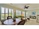Bright sunroom with large windows, comfortable seating, and a ceiling fan at 310 Waterlily Way, Summerville, SC 29486