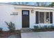 Close-up of the front door, stylish exterior lighting and the house number against the white siding at 3113 Matipan Ave, North Charleston, SC 29405