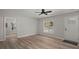 Freshly painted living room boasts gray vinyl floors, an exterior door and a bright window at 3113 Matipan Ave, North Charleston, SC 29405