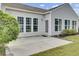 Backyard with a patio and a view of the home's exterior featuring white siding and many windows at 349 Waterlily Way, Summerville, SC 29486