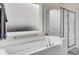 Clean and bright bathroom featuring a modern tub and glass-enclosed shower at 349 Waterlily Way, Summerville, SC 29486