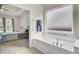 Bright bathroom showcasing a soaking tub with frosted window and a glimpse into the bedroom at 349 Waterlily Way, Summerville, SC 29486