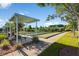 Bocce ball courts surrounded by lush landscaping and covered seating areas at 349 Waterlily Way, Summerville, SC 29486