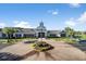 Beautiful community clubhouse with circular driveway, manicured flower bed and American flag at 349 Waterlily Way, Summerville, SC 29486