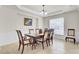 Bright dining room with tray ceilings, neutral decor, and a large window providing natural light at 349 Waterlily Way, Summerville, SC 29486
