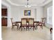 Elegant dining room featuring a traditional table set for six, crown molding, and neutral tile flooring at 349 Waterlily Way, Summerville, SC 29486
