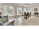Sunny dining room with large windows offering serene pond views, seating four at 349 Waterlily Way, Summerville, SC 29486