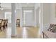 Bright foyer featuring neutral tile flooring, white columns, and a view into the dining area and front entrance at 349 Waterlily Way, Summerville, SC 29486