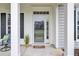 Inviting front entrance featuring a glass-paneled door, white columns, and a welcoming 'Hello' doormat at 349 Waterlily Way, Summerville, SC 29486