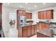Stylish kitchen with island, stainless steel refrigerator, and granite countertops at 349 Waterlily Way, Summerville, SC 29486