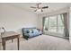 Bright living room featuring large windows, neutral carpet, ceiling fan, and comfortable blue futon at 349 Waterlily Way, Summerville, SC 29486