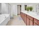 Spa-like main bathroom features a double vanity, soaking tub, and glass-enclosed shower at 349 Waterlily Way, Summerville, SC 29486