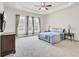 Serene main bedroom with tray ceiling, three windows, and plush carpeting at 349 Waterlily Way, Summerville, SC 29486