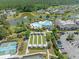 Aerial view of a swimming pool, bocce ball court, clubhouse, and stocked ponds in the neighborhood at 361 Waterlily Way, Summerville, SC 29486