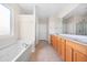 Bright bathroom features a soaking tub, ceramic tile floor, and a long vanity with double sinks at 361 Waterlily Way, Summerville, SC 29486