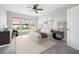 Serene bedroom boasts a cozy bed, soft carpet, a ceiling fan, and bright windows with attractive blinds at 361 Waterlily Way, Summerville, SC 29486
