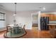 Bright dining room featuring a white table, four chairs, and hardwood floors at 361 Waterlily Way, Summerville, SC 29486