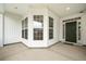 Covered entrance featuring a bay window nook on the porch and a dark green front door with sidelights at 361 Waterlily Way, Summerville, SC 29486