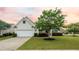Charming single-Gathering home featuring a well-manicured lawn, attached garage, and classic white siding at 361 Waterlily Way, Summerville, SC 29486