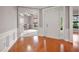 Inviting foyer with hardwood floors and white trim opens to a bright office space with French doors at 361 Waterlily Way, Summerville, SC 29486
