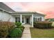 Cozy covered front porch with decorative columns and immaculate landscaping provides a welcoming entrance at 361 Waterlily Way, Summerville, SC 29486