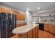 Well-lit kitchen with wood cabinets, island, and stainless steel refrigerator at 361 Waterlily Way, Summerville, SC 29486
