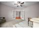 Bright, carpeted home office featuring French doors, a ceiling fan, and neutral decor for a calm workspace at 361 Waterlily Way, Summerville, SC 29486