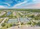 Aerial view of tennis courts, a playground, and neighborhood homes with beautiful landscaping at 361 Waterlily Way, Summerville, SC 29486