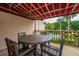 Cozy outdoor patio with a table and chairs overlooking the community pool area and greenery at 408 Yacht Harbor Ct # Share 2, Isle of Palms, SC 29451