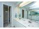 Bright bathroom featuring a double sink vanity with granite countertops and a large, mirrored wall at 408 Yacht Harbor Ct # Share 2, Isle of Palms, SC 29451