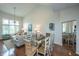 Bright and airy dining area with hardwood floors and a mirrored wall reflecting the inviting living space at 408 Yacht Harbor Ct # Share 2, Isle of Palms, SC 29451
