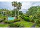 Relaxing community pool area featuring palm trees, lounge chairs, and a lush green walkway at 408 Yacht Harbor Ct # Share 2, Isle of Palms, SC 29451