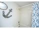 Nautical-themed bathroom with decorative anchor and shower/tub combination with shower curtain at 408 Yacht Harbor Ct # Share 4, Isle of Palms, SC 29451