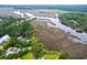 Aerial view of marsh and river with home and community in a private location at 4385 Ten Shillings Way, Ravenel, SC 29470