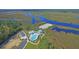 Aerial view of pool and waterfront amenity center with a beautiful river landscape at 4385 Ten Shillings Way, Ravenel, SC 29470
