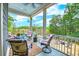 Outdoor back porch featuring ample seating, string lights, and a beautiful view of the backyard at 4385 Ten Shillings Way, Ravenel, SC 29470